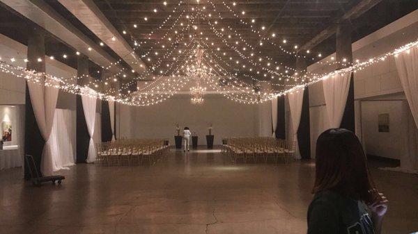 Gorgeous lighting for my ceremony . Curtains were also hung on the side to hide tables during ceremony