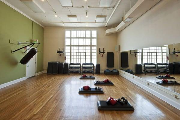 Group fitness and boxing clinic studio in a space formerly used as a dance studio and dress shop.