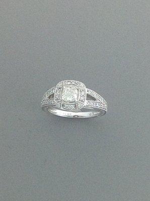 Beautiful halo surrounds this center diamond with a split shank set with diamonds