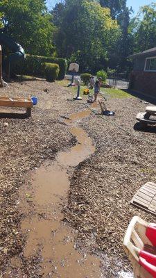 The children working together to make a river.