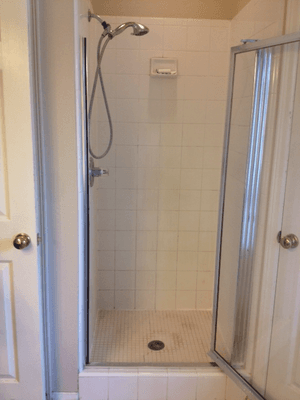 This shower was coated with soap scum and just needed a good cleaning, sealing, and re-grouting in the corners and edges.