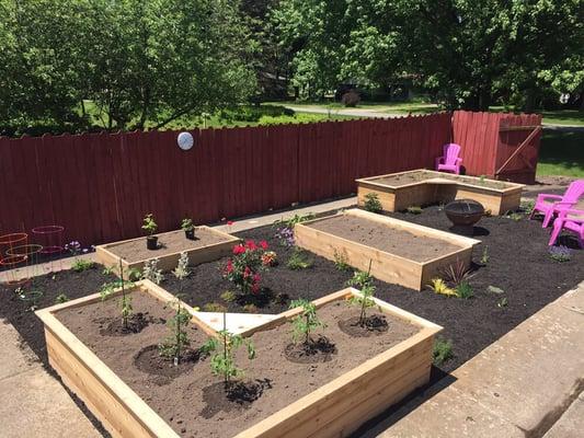 Custom garden boxes and fresh mulch turned this boring grass rectangle into a fun garden!