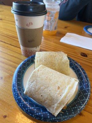 Coffee and a breakfast wrap with egg, cheese, and sausage.