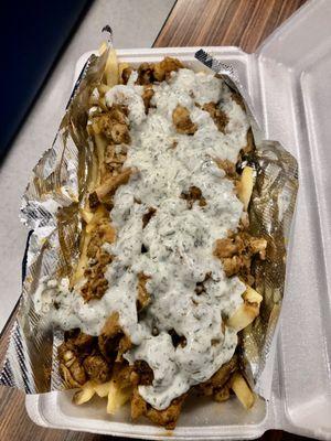 Chicken Doner over a bed of fries with tzatziki sauce