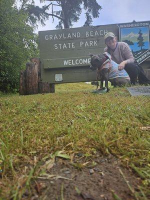 My dog and I posing at the sign