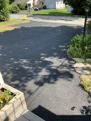 Amazing attention to detail: cutting around the stones and pavers, and tying into the towns curbing.