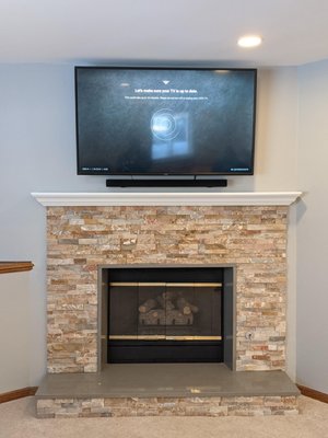 Above fireplace TV Mounting with Soundbar and wire concealment.