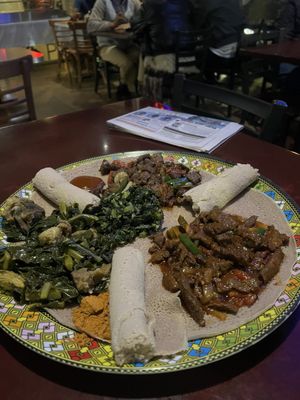 3 meat and veggie Sheger Combination, Gomen Besiga, Special Awaze Beef, and Tibs Lamb