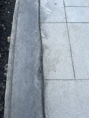 Stain splashed chipped concrete and horrible saw cuts