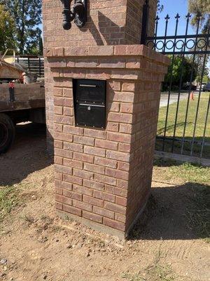 It's a very large brick mailbox surround with locking mailbox.