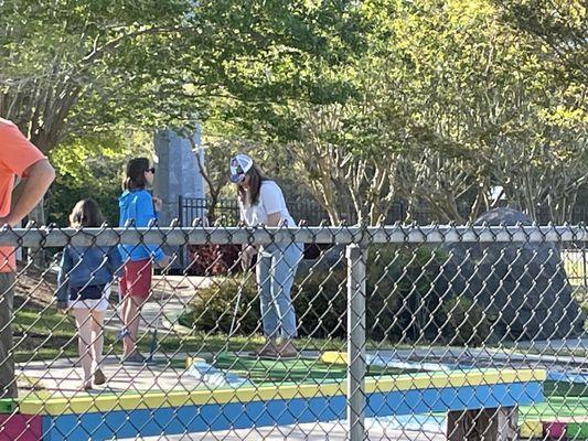 My daughter and grandkids playing miniature golf.