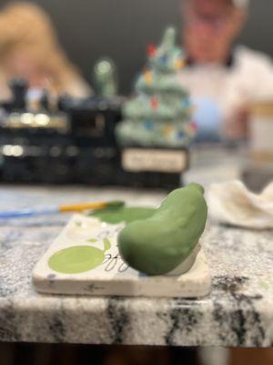 Black Friday ceramic painting with the family. This is the foundation of a Christmas Pickle.