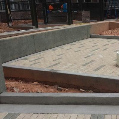 Liquid Pressure,Inc., at work around a pool deck under construction in Charlotte, North Carolina