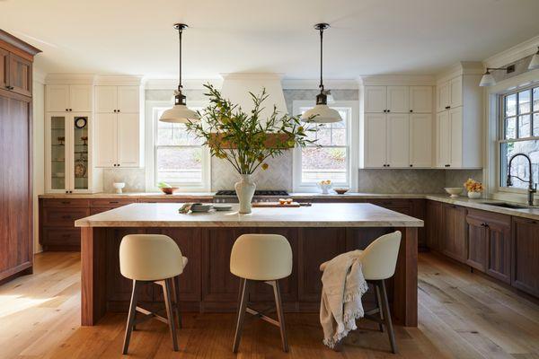 Elegant kitchen with walnut cabinetry and warm tones.