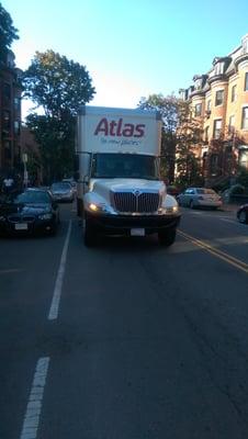 Parked van blocking major street during rush hour.