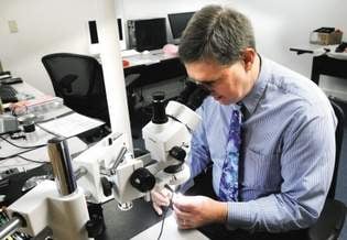 Owner Richard Gurecki examines an iPhone for data recovery