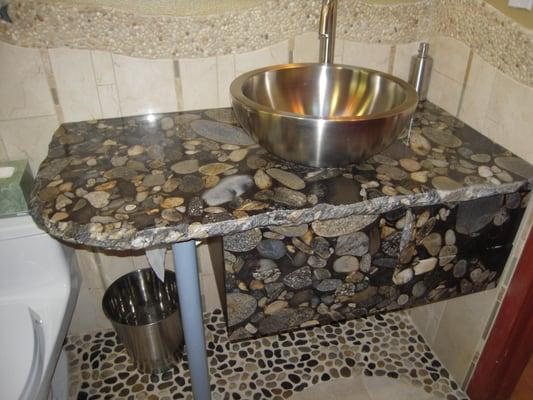 Stone top and cabinet facing.  Pebble floor and wall design.