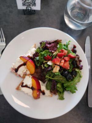 Delicious summer salad with fresh fruit and homemade bread with ricotta,ham, peach and balsamic.