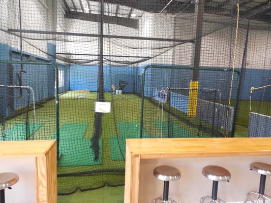 Batting and pitching lanes featuring an Iron Mike BB pitching machine and 2 Juggs softball machines