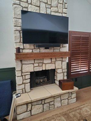 Here you can see a 55" Samsung TV installed with a MantelMount MM700 above our fireplace.