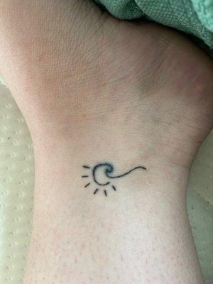 Upside down... but this is the wave and sun tattoo. Lines are a little shaky.