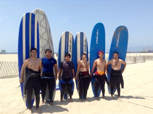 They are ready to catch waves on their Surfing Lesson