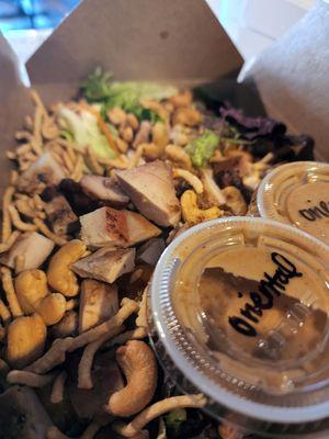 oriental salad- chicken, cashews, noodles,  romaine,  mixed greens,  cabbage,  carrots , onions and green onions with a sesame dressing