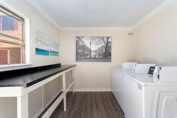 Newly renovated and improved laundry room. With new washers and gas-powered dryers.