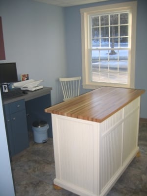 Exam room with windows and wooden tables for patient comfort