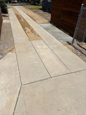 New cement pad for trash cans. Grading and DG in the driveway.