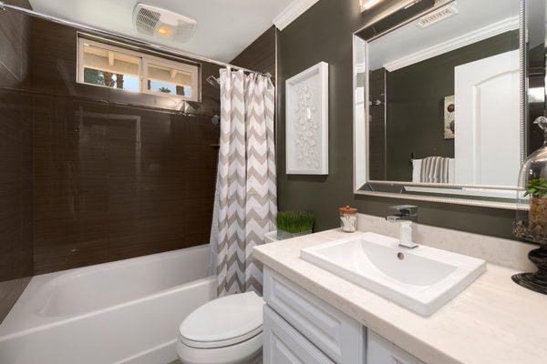 Good things come in small packages. Old fiberglass shower replaced with porcelain tile, new colors, sharp vanity, top, faucet, and mirror.