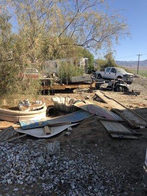 Another pile of garbage located on behind the food truck.