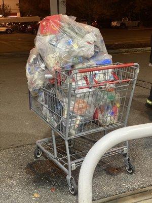 Trash removed from gas pumps trash cans inside of a shopping cart utilized by customers!