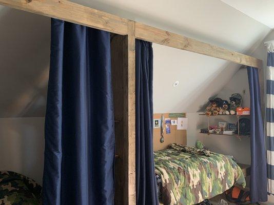 Built in loft beds with shelving, cubbies and lights in each.