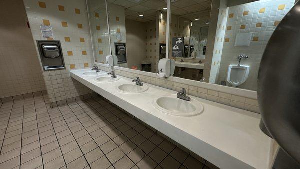 Clean counters in the bathroom. No paper on floor or splashes anywhere.