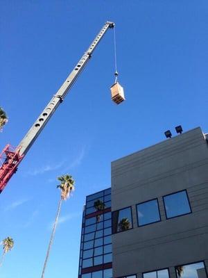 New storage tank craned up to roof. 2 new Hot water storage tanks