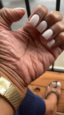 SNS nails with white gel polish on toes.