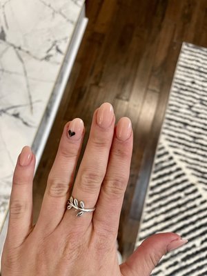 Dip powder manicure with tips and black heart design