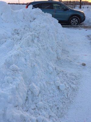 Hard packed snow from lazy plow driver left in parking spot