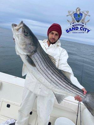 Kory with his personal best striped bass