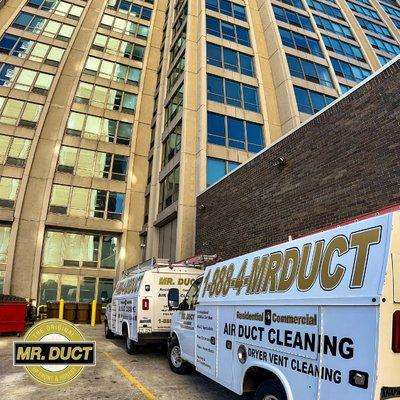 Mr. Duct trucks outside of a commercial air duct cleaning site in Chicago.