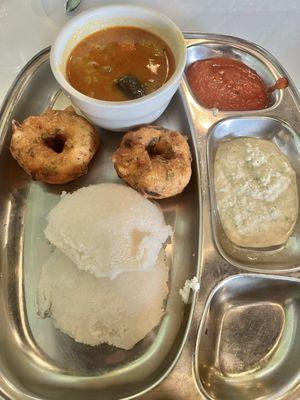 My order of Mixed Idli white cooked rice/udard mix and Medu wada brown spice donuts with sambhar in cup with chutney