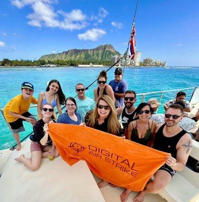 DAS employees and family members have fun on a catamaran during the 2023 President's Club trip in Hawaii.