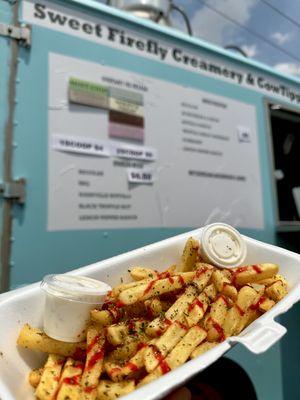 Truffle garlic Parmesan fries drizzled with a black truffle hot sauce