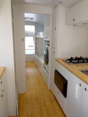 Cali bamboo flooring in a clean white design with an LG washer/ventless dryer combo.