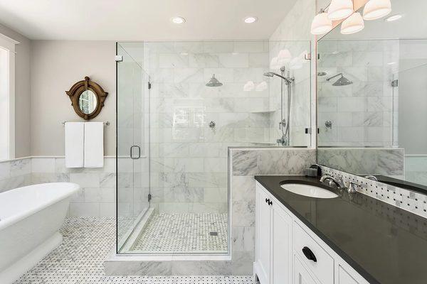 Novabuilt Homes is setting the New Standard in this modern bathroom with open glass shower and continuous tile throughout!