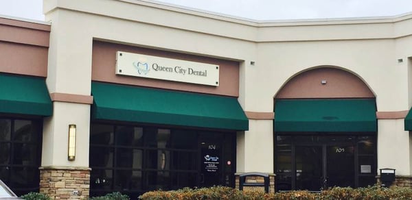 front door sign for Queen City Dental