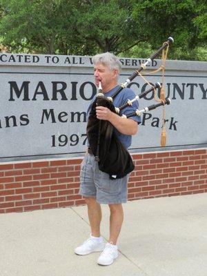 John...practicing on his bagpipe for the up-coming ceremony. (Memorial Day)