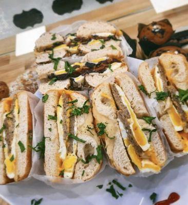 Bacon, sausage egg and cheese served on a bagels