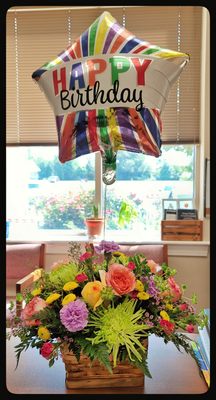 Jeanine's birthday floral arrangement on display in her office.